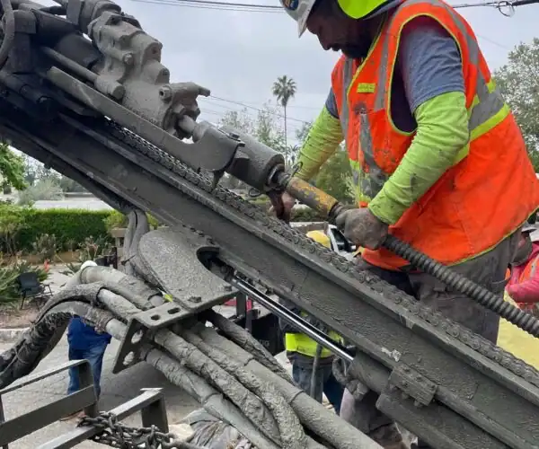 Avari Foundation Repair Services crew installing hillside tiebacks and soil nails on a residential slope in Southern California.
