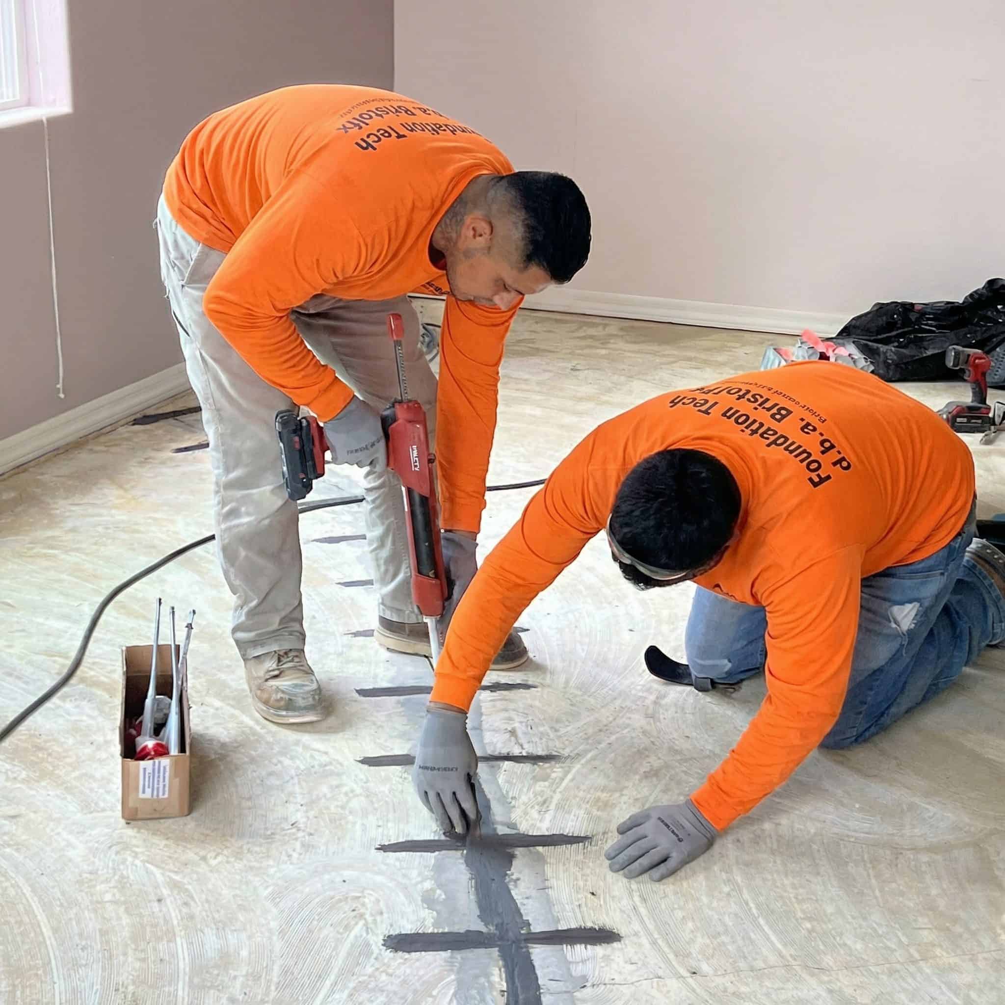 Crack injection and carbon fiber staples to repair a slab foundation.